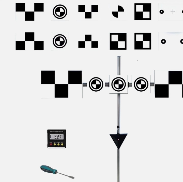 ADAS calibration target panels on a stand with a digital angle gauge and hand tools